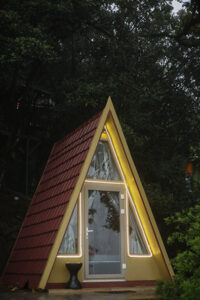 Charming A-Frame Hut at Cloud Cabana Holidays Vagamon with panoramic views of the lush Vagamon landscape.