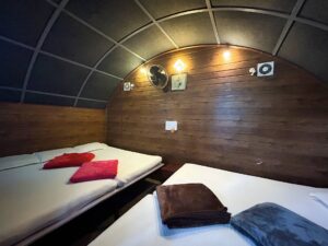 Spacious interior of the Tent House at Cloud Cabana Holidays Vagamon, designed for group camping with cozy and comfortable features.