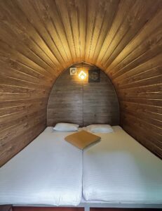 Warm and inviting interior of Cozy Cabin at Cloud Cabana Holidays Vagamon, featuring comfortable seating and rustic decor.