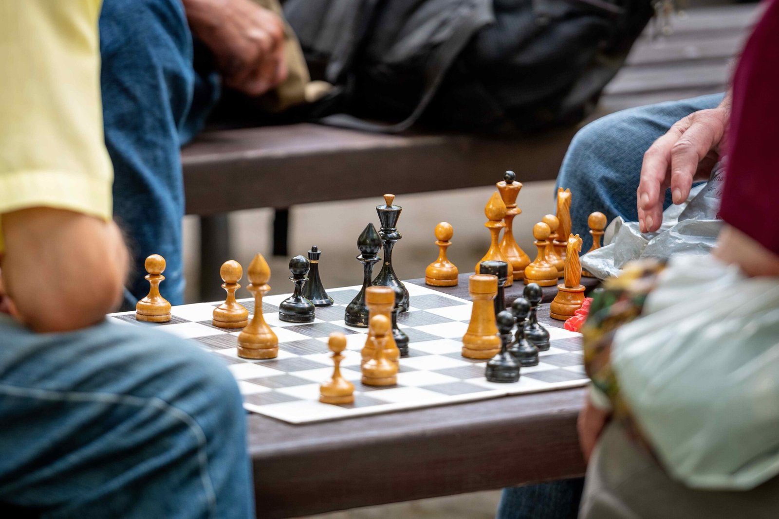 Guests enjoying a game of chess indoors at Cloud Cabana Holidays Vagamon, featuring a classic chessboard and relaxed atmosphere.